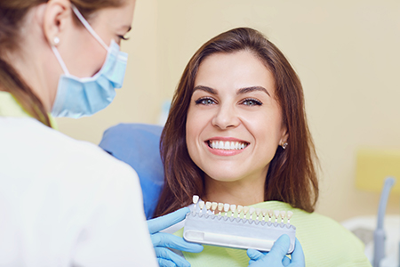 A dentist with a patient, showing dental care equipment and tools.
