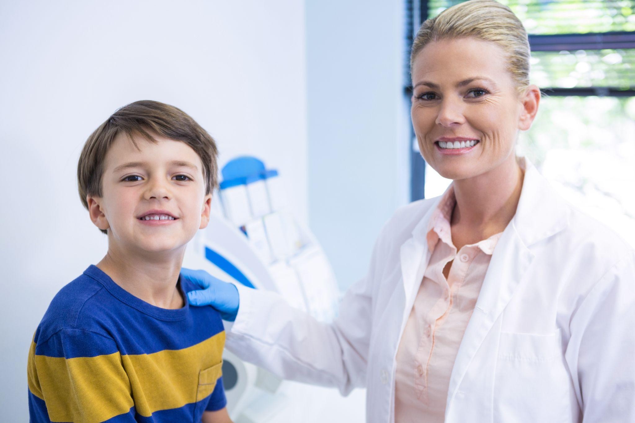 Smiling boy with dentist during a general dentistry visit at Corona Family Dental in Sarasota FL.