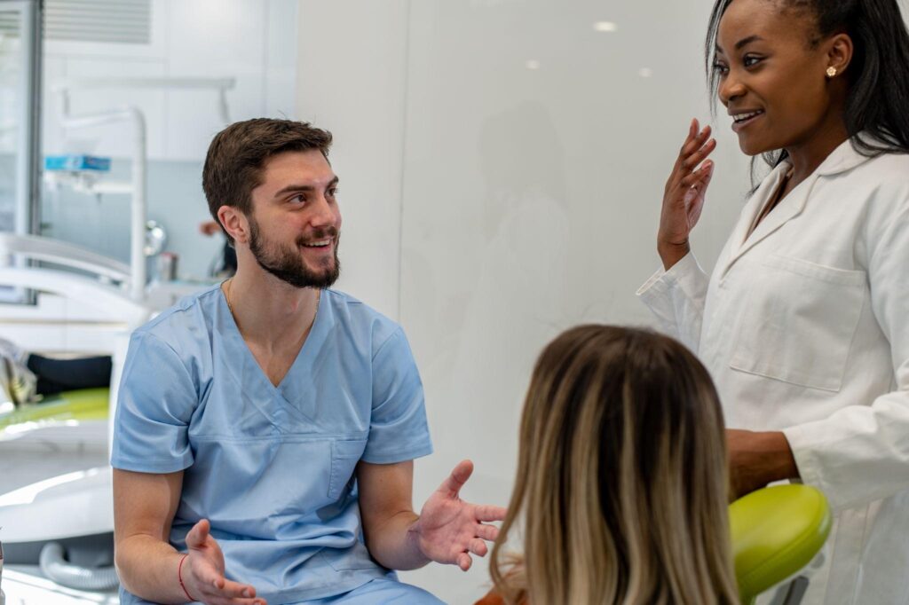Implant dentist in Sarasota talking with patient during consultation about dental implants and restorative dentistry options.