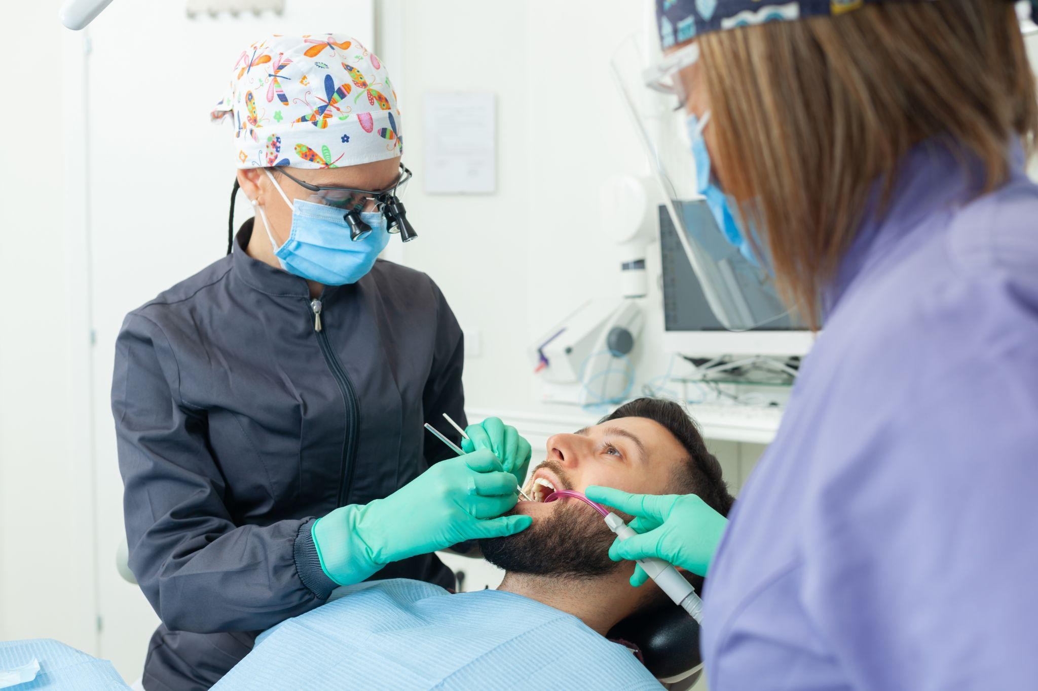 Dentists Bradenton FL performing a dental exam on a patient, showing what to expect at a first repair visit and how dentist visit cost is explained clearly.