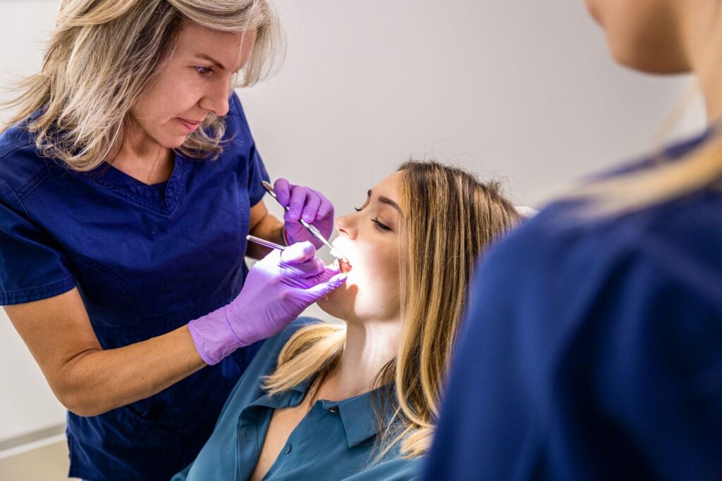 Female cosmetic dentist examining patient’s teeth during cosmetic dentistry appointment in Bradenton.