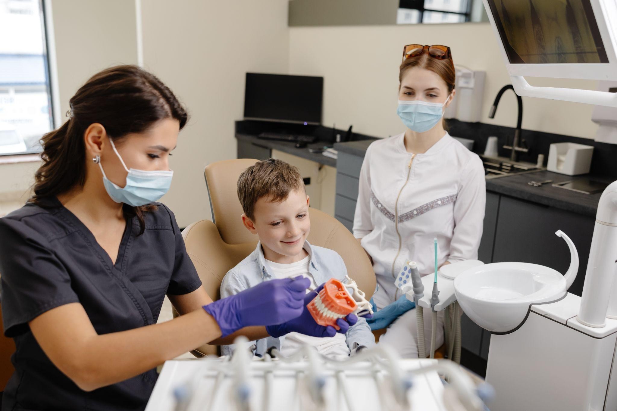 Young boy learning about dental care with a hygienist at a family dental Sarasota clinic.